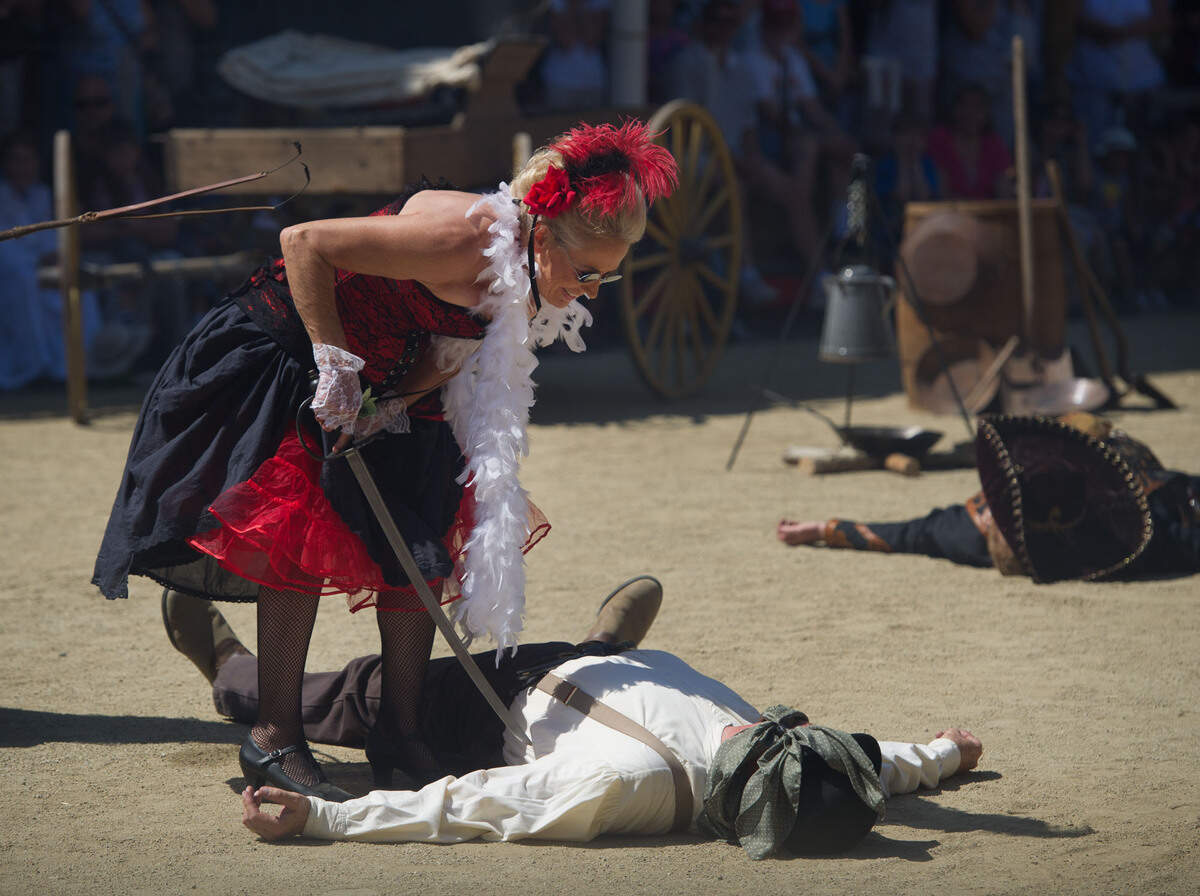Lou Kemler checks out a "dead" squatter during a re-enactment of the Squatter's Riot of 1850 during Gold Rush Days in Old Sacramento in 2011.